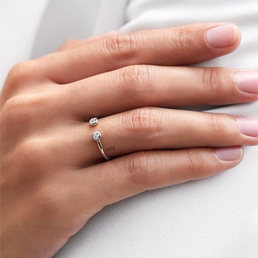 Open adjustable ring with two bezel stones.