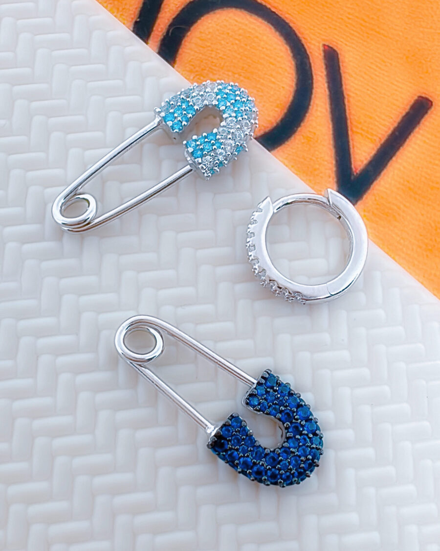 huggie hoop with dangling pin shape.