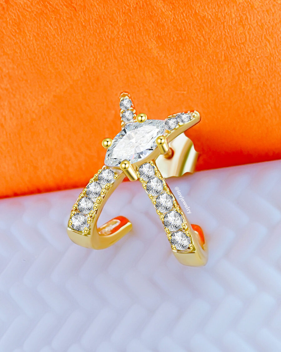 X shape huggie hoop with marquise center stone.