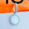 9mm CZ hoop earring with a mother of pearl dangling in a halo setting.