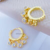 9mm huggie hoop earring with dangling CZ stones in bezel setting.