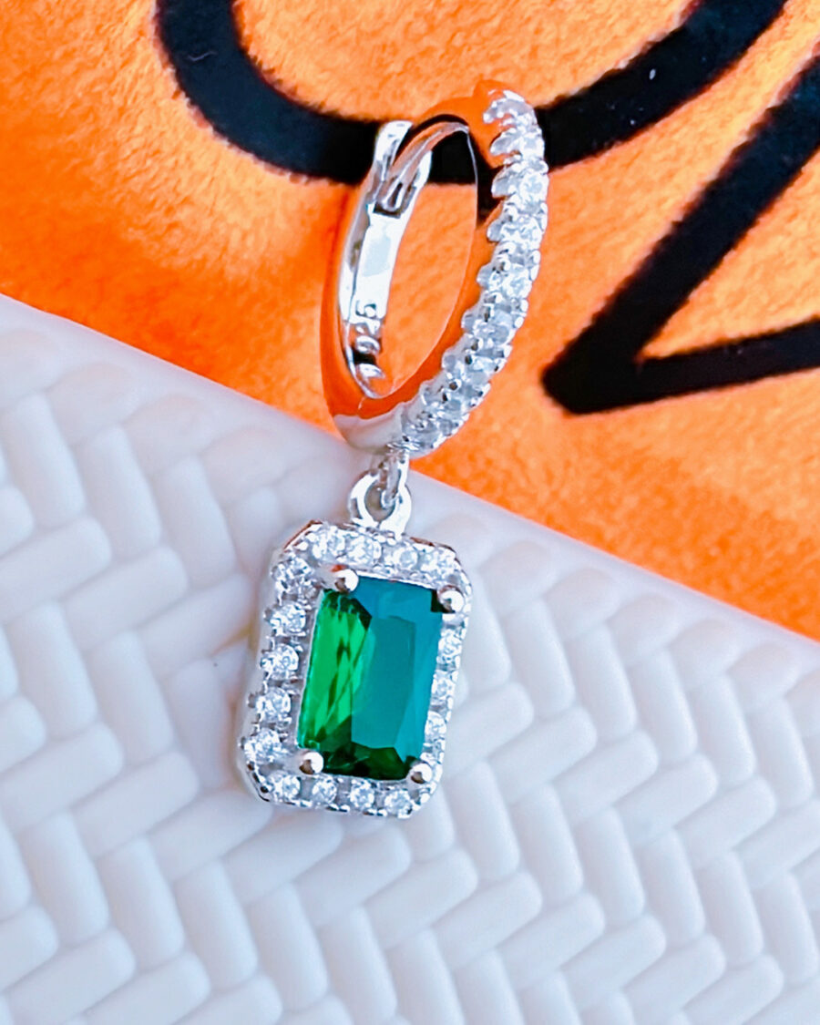 huggie hoop earring with dangling emerald color stone in halo setting. - Image 3
