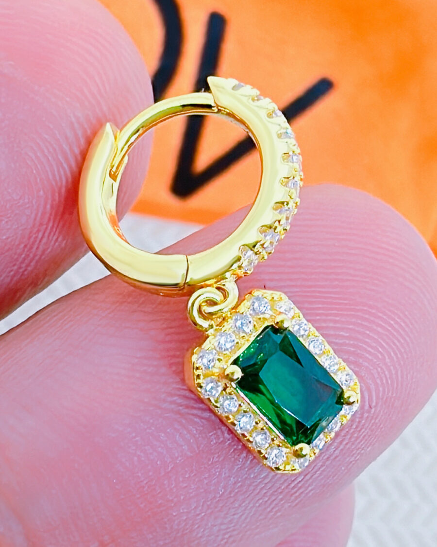 huggie hoop earring with dangling emerald color stone in halo setting. - Image 2