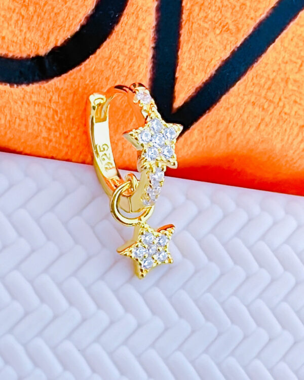 CZ huggie star hoop with dangling star shape.