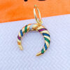 plain hoop with dangling crescent shape studded with colorful CZ.