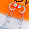 crescent shape stud earring with dangling chains.
