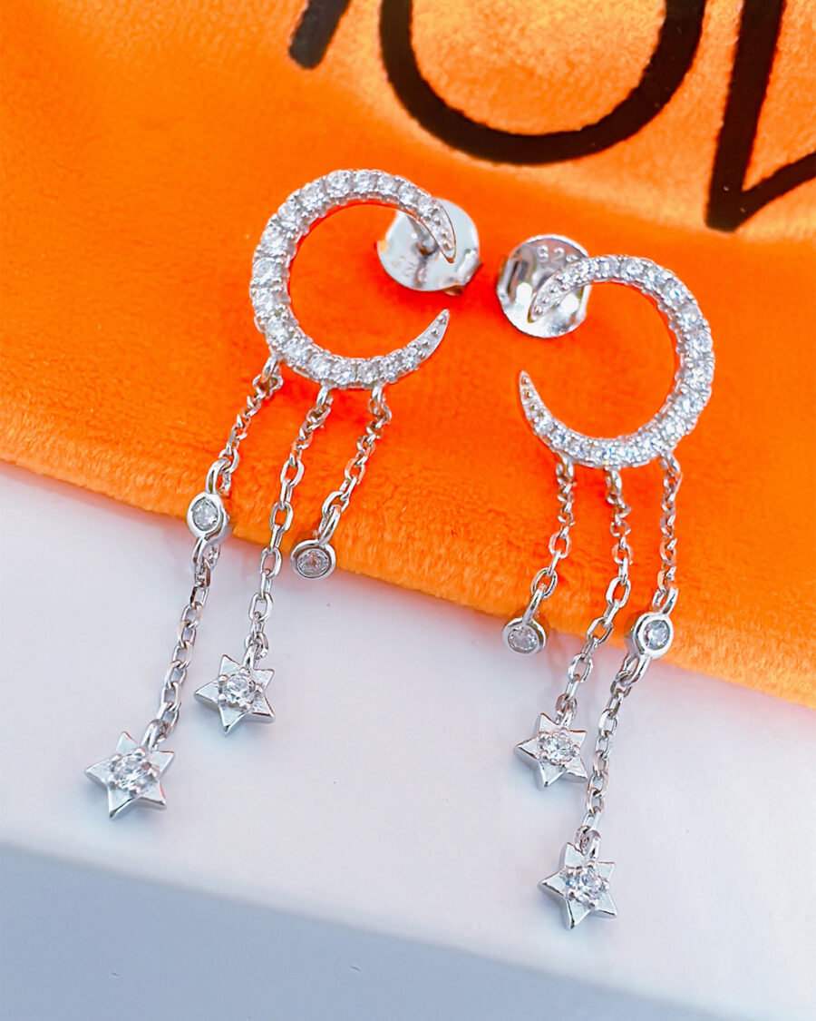 crescent shape stud earring with dangling chains.