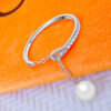 simple adjustable size open ring with dangling pearl.