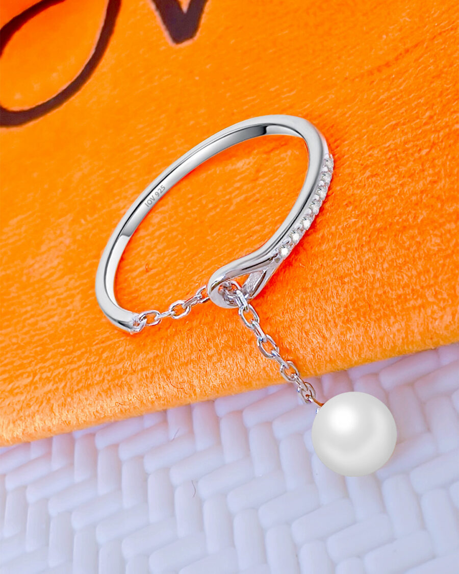 simple adjustable size open ring with dangling pearl.