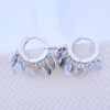 plain huggie hoop earring with dangling disc shapes.