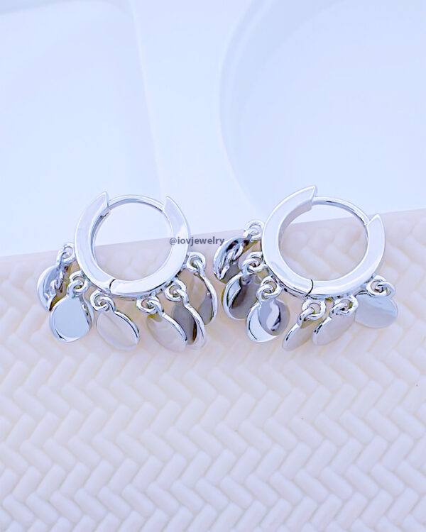 plain huggie hoop earring with dangling disc shapes.