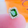 CZ emerald color rectangular stone in a halo setting stud earring.