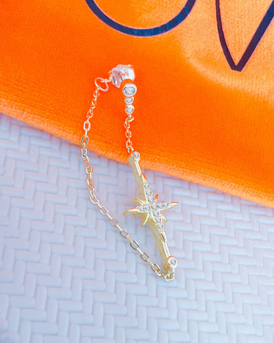 back to front chain earring with dangling star.