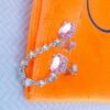 double oval pink stones linked with CZ in prong setting links.