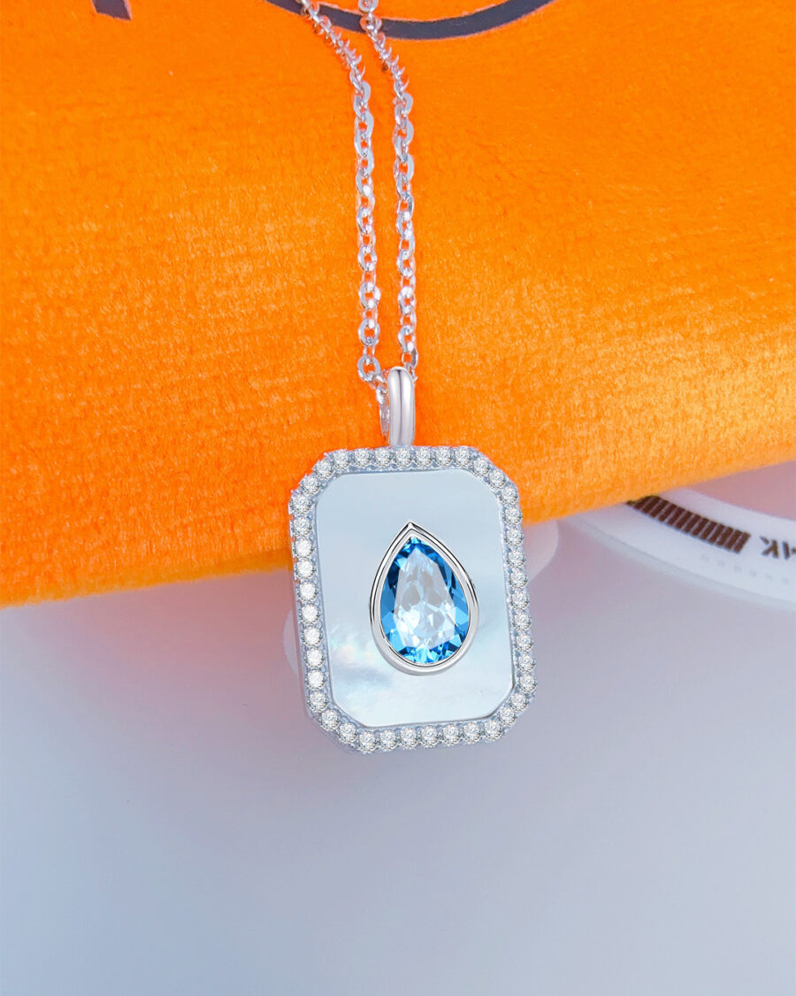 rectangular MOP necklace with pear shape aquamarine color CZ stone.
